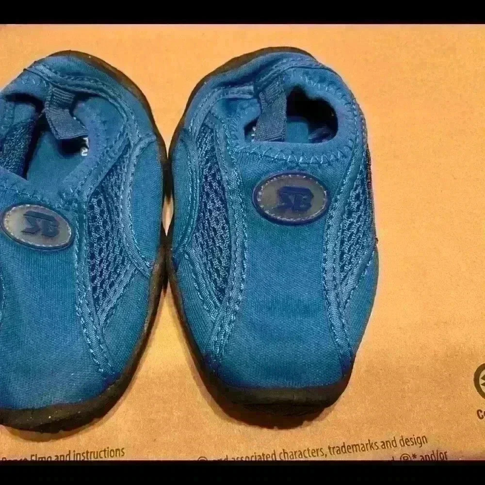 BOY swim shoes size 6 never worn.​​​​​​​​​​​​​​​​​​​
